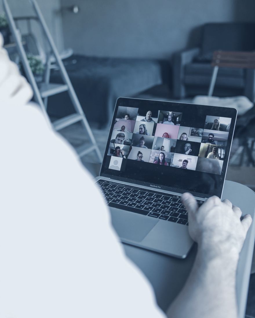 A manager on a video call with a remote team in the Philippines